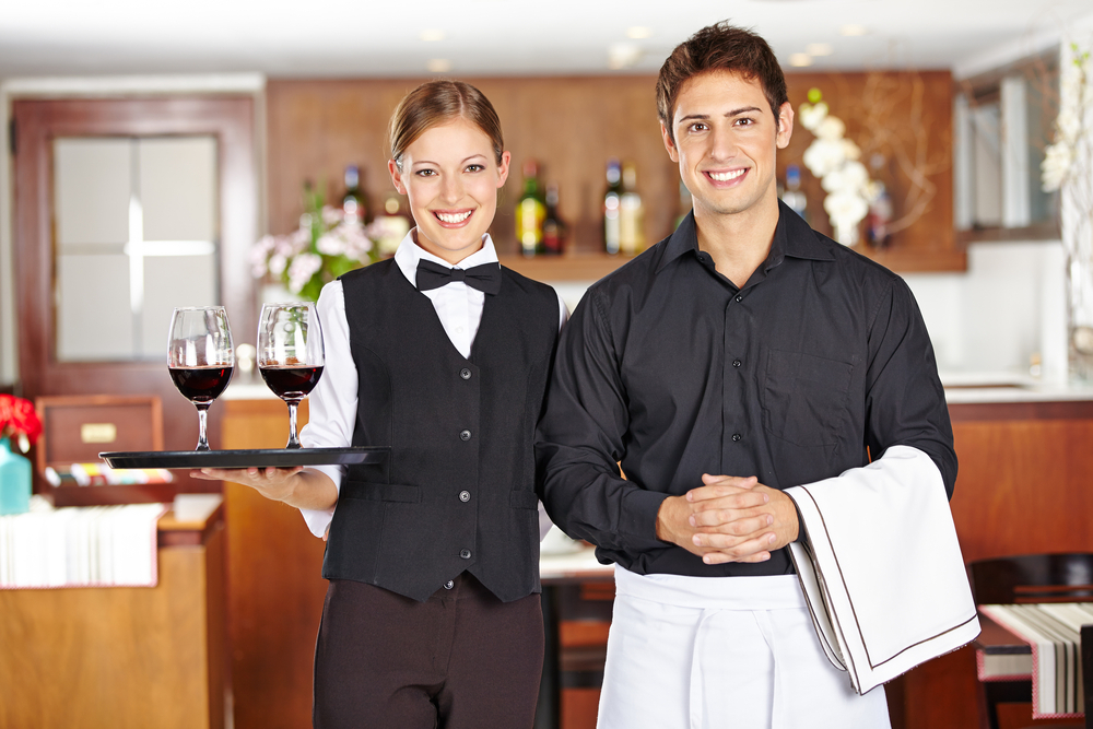 Two Waiters Holding their Accessories